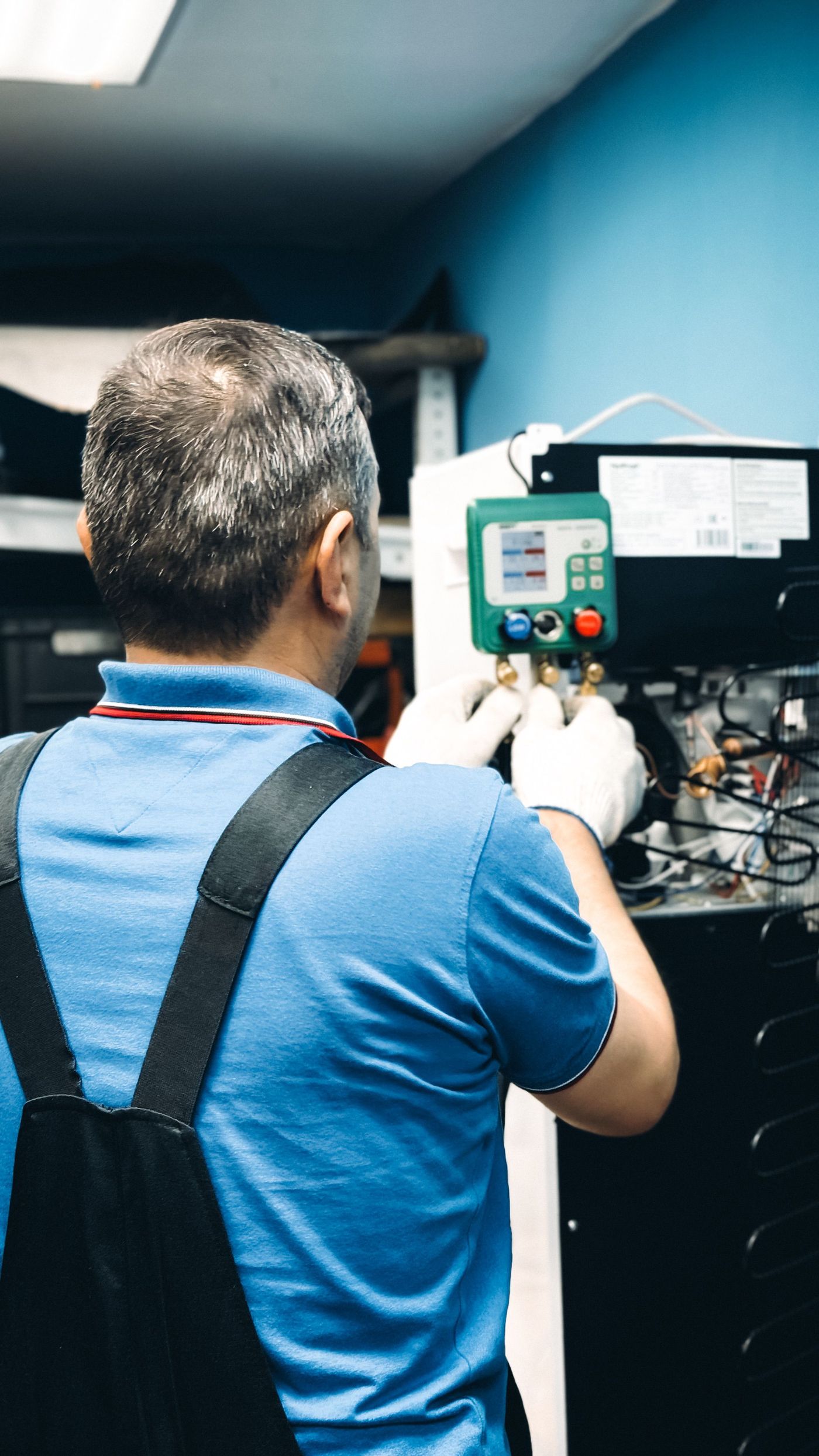 Technician servicing an indoor air-conditioning unit